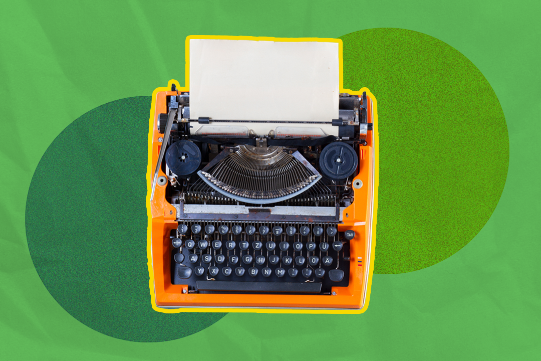 orange typewriter against a green abstract background